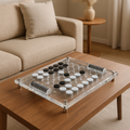 Close-up of black and white discs on clear acrylic Othello board