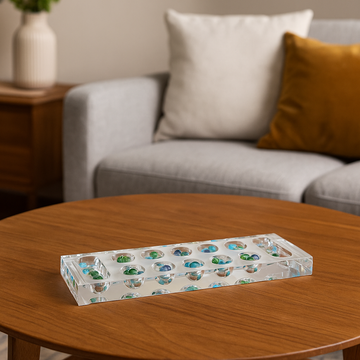 Lucite Mancala game styled on a modern coffee table